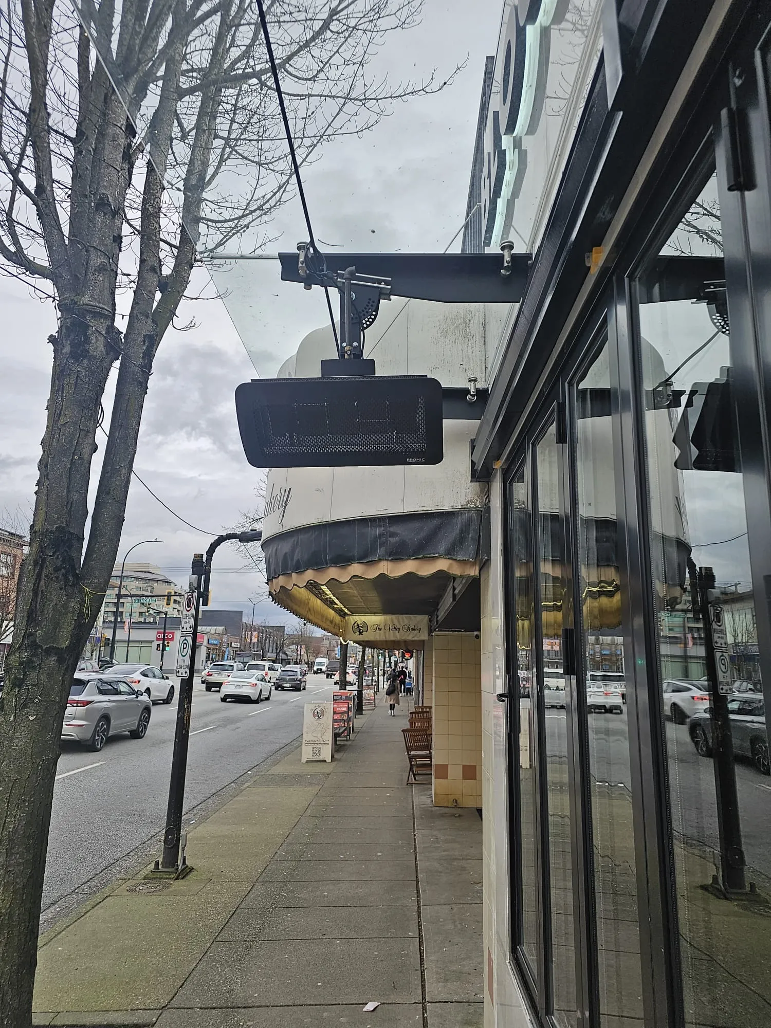 Commercial outdoor gas patio heater installation by Budget Heating Lower Mainland BC - Bromic heater mounted on storefront entrance