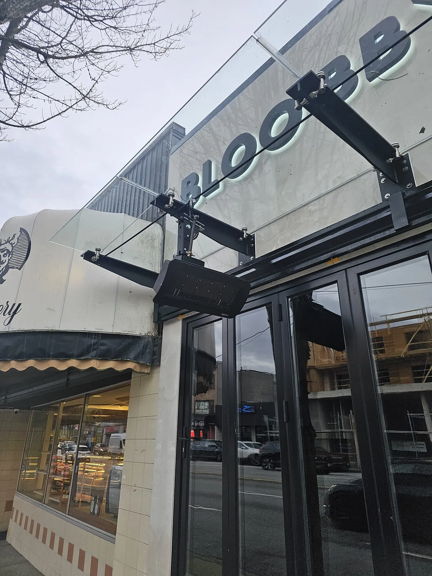 Bromic patio heater mounting hardware and bracket installation on commercial storefront entrance Lower Mainland BC by Budget Heating